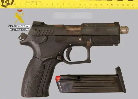 Civil Guard A police photograph of a handgun with a silencer.