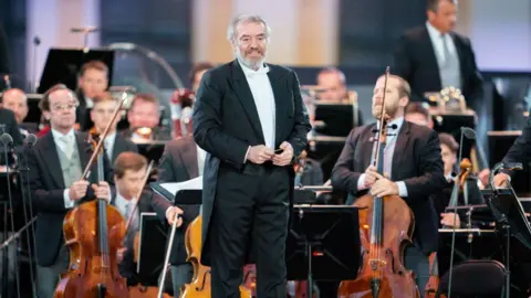 GEORG HOCHMUTH/APA/AFP Russian conductor Valery Gergiev performs on stage with the Vienna Philharmonic Orchestra in 2020