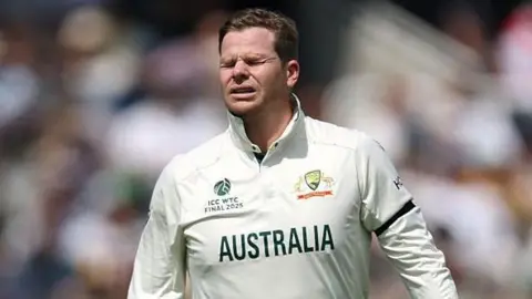 Steve Smith grimaces as he leaves the field at Lord's after dislocating his finger