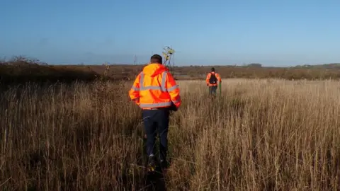 Leicestershire County Council People walking through tall grass