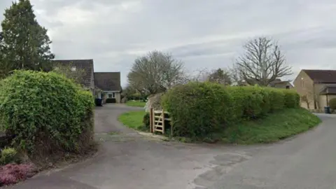 Google Temple Farm, Upton Scudamore. A small wooden gate is on a path leading from the road to a house