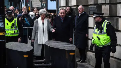 Getty Images Former Scottish National Party leader Alex Salmond (C) leaves after a preliminary hearing over allegations of sexual harassment, at the High Court in Edinburgh on January 22, 2020. - Scotland's former first minister Alex Salmond appeared in court on Thursday to face a string of sexual assault allegations, including an attempted rape at his official residence in 2014. A total of 10 women have made complaints against the 64-year-old, who led the Scottish National Party for more than 20 years.