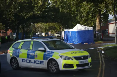 PA Media A picture of the police scene in Ascot Drive in Derby on the day Mr Ciolac died. 