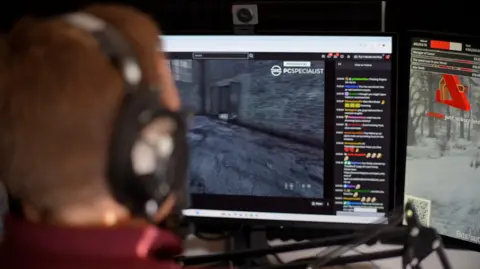 Jamie Niblock/BBC TheRunningManZ photographed from over his shoulder as he plays a game. 