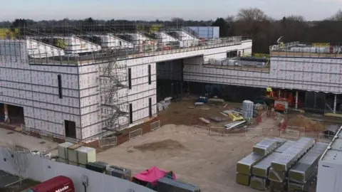 Anglia Ruskin University Anglia Ruskin University Peterborough's new lab under construction,  showing an incomplete building covered in scaffolding