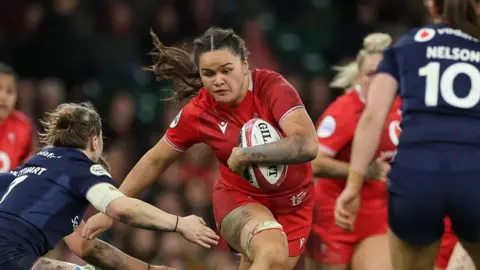 Jorja Aiono carries the ball for Wales