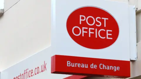 PA A red Post Office sign above a red Bureau de Change sign