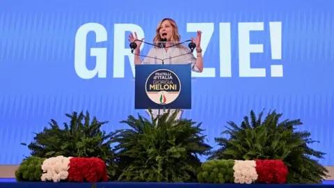 Reuters Giorgia Meloni speaks at an election night rally