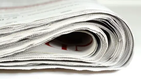 Getty Images A stock image shows the edge of a folded newspaper.