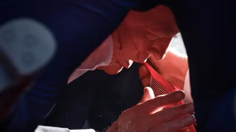 Getty Images Trump with blood on his face