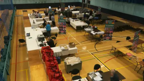 A series of tables at Beau Sejour Sports Hall where ballots are being counted for Guernsey's 2020 general election. 