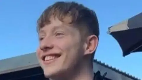 Police Scotland A young man smiling and looking obliquely to the camera