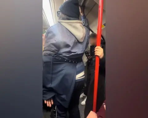 BTP A photo taken on a busy tube, which captures Levy using his clothing to conceal his hand