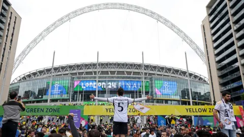 PA Media Football fans outside Wembley