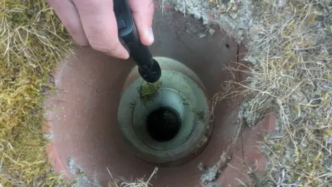 RSPCA A torch being shone into a 7ft ground pipe