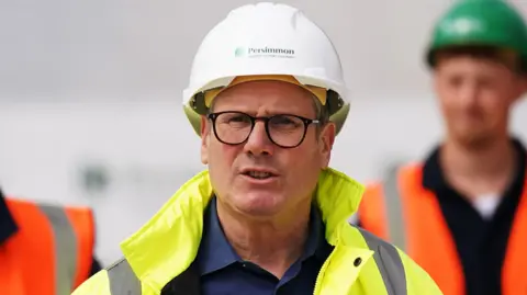 Prime Minister Sir Keir Starmer wears a high visibility jackets and hard hat