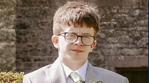 A man in glasses wearing a suit