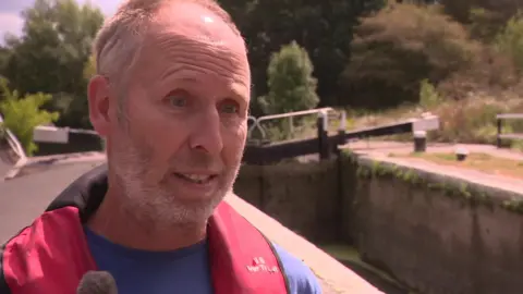 Colin Beesley standing at a lock in west London.