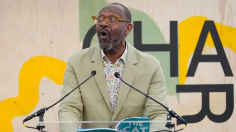 Sir Lenny Henry reading at a festival