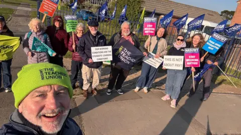 NASUWT South West NASUWT South West members stood outside the blue gates of Budmouth Academy with their banners.