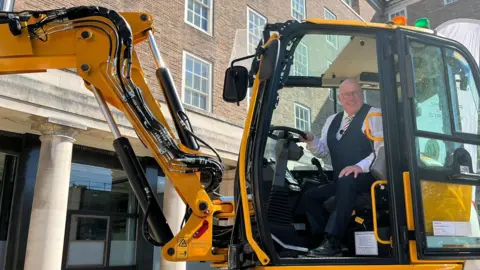 Nottinghamshire County Council leader Mick Barton in a JCB Pothole Pro
