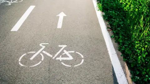 Getty A white cycle marking on a grey road.