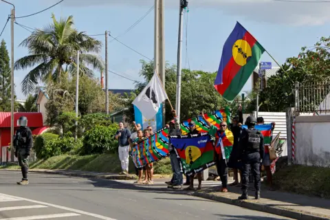 Kanak activists carrying New Caledonia flags