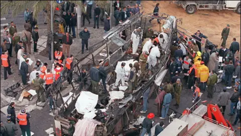 AFP Israeli rescue teams search for bodies of victims inside the wreckage of a bus which was destroyed 03 March 1996 by a suicide bomber in central Jerusalem. At least 20 Israeli were killed in the blast. 