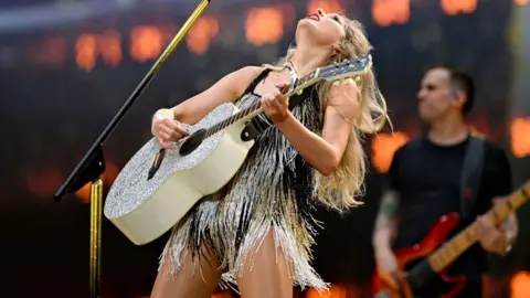 Getty Images Taylor Swift playing her guitar