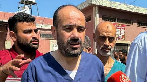 Dr Mohammed Abu Salmiya (L) and a colleague walks to a press conference at Nasser hospital in Khan Youins, in the southern Gaza Strip, following their release from Israeli detention (1 July 2024)