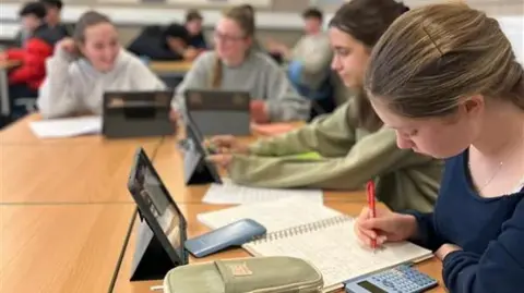 Pupils using iPads at school. 