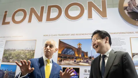 PA Media Mayor of London Sadiq Khan (left) chats with the Prime Minister of Singapore, Lawrence Wong