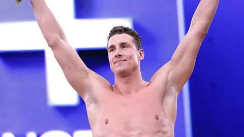 Kristian Gkolomeev celebrates winning the men's 50m freestyle at the Enhanced Games