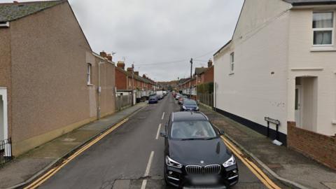 St Martin's Road in Canterbury. A small residential street. There is a black BMW in the foreground.