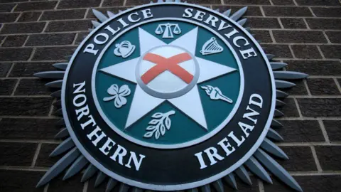 PSNI logo on brick wall 