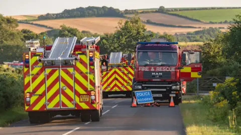 Lewis Johnstone Three fire engines parked on a rural road