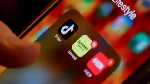 An iPhone user with the TikTok app and alternative apps RedNote and Lemon8