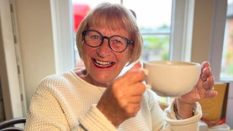 Ann Weymouth from Writtle, holding a cup of coffee in The Lordship tea rooms in Writtle, Essex