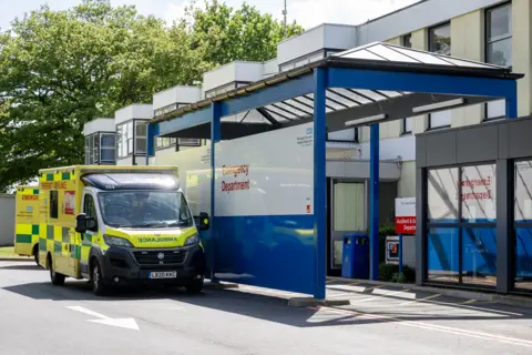QEH External view of the hospital with an ambulance pulled up outside. 