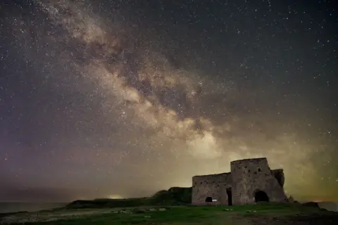 Alan Rankin The Milky Way in the night sky. The ruins of a building sit in the foreground.
