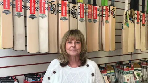 Matt Knight/BBC Owner Angela Price standing in her sports shop 