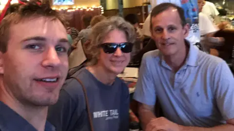 Kym McGillicuddy Three people smile for a selfie in a restaurant 