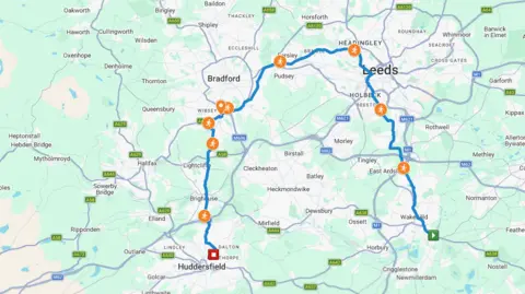 Google The image is a map of West Yorkshire showing a plotted running route in a stage of Kevin Sinfield’s challenge. The map centres on Leeds, Bradford and Huddersfield, with surrounding towns including Wakefield, Halifax and Keighley. A blue line marks the route of the run.