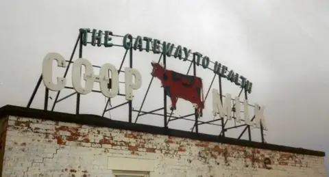 Central Co-op The original sign on top of a building in Derby city centre at which reads THE GATEWAY TO HEALTH COOP MILK