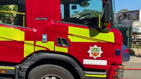 A red fire engine with a Humberside Fire and Rescue Service logo