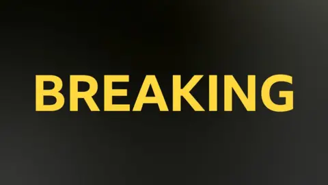 BBC Sport breaking news image. Breaking written in yellow capital letters on a black background.