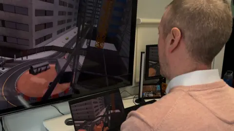An over the shoulder shot of a man with grey hair and a salmon jumper looking at VR footage being cast to multiple screens.