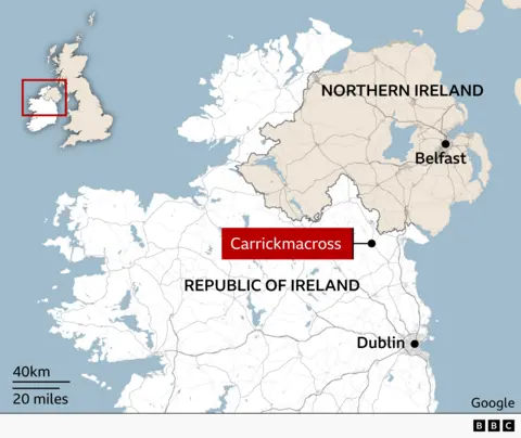 Map of the island of Ireland showing the location of Carrickmacross in County Monaghan, close to the border between the Republic of Ireland and Northern Ireland. Northern Ireland is shaded in beige and labelled, with Belfast marked to the east. The Republic of Ireland is shown in light grey, with Dublin marked on the east coast. An inset map of the British Isles highlights the island of Ireland.