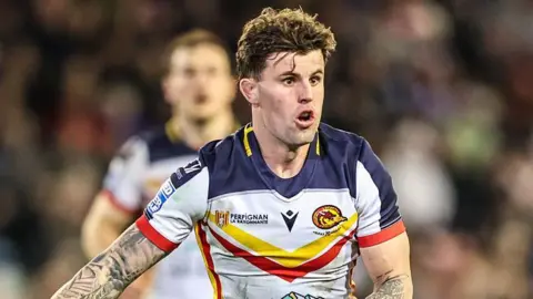 Toby Sexton standing on the pitch during a match