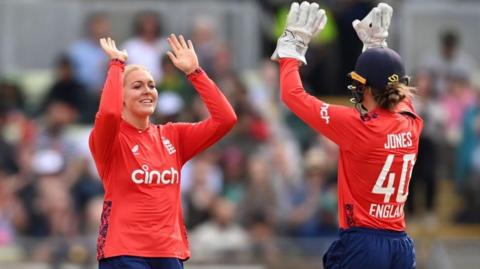 Sarah Glenn and Amy Jones celebrate a wicket for England